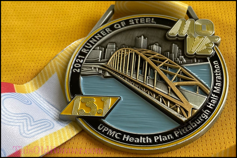 Close up view of the 2021 Pittsburgh Half Marathon Finisher Medal.
