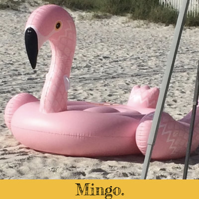 Inflatable pink flamingo beach float.