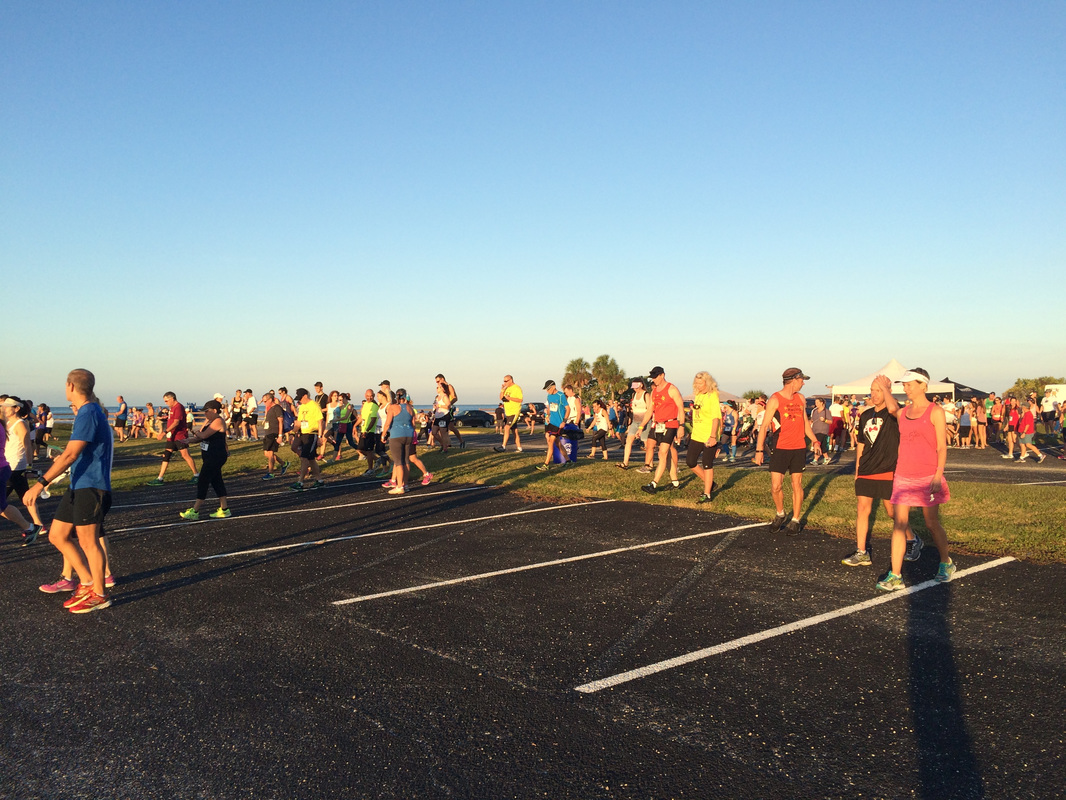 Runners cross the parking lot to the starting line of the Honeymoon Island Half.