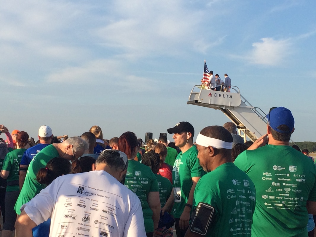 Runners gather at the starting line of the 5K on the Runway at TIA.