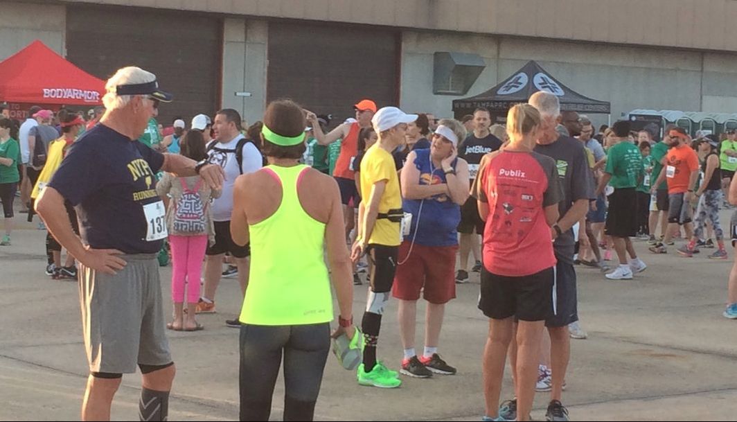 Runners gather on the tarmac near the runway before the 2017 5K on the Runway Race.